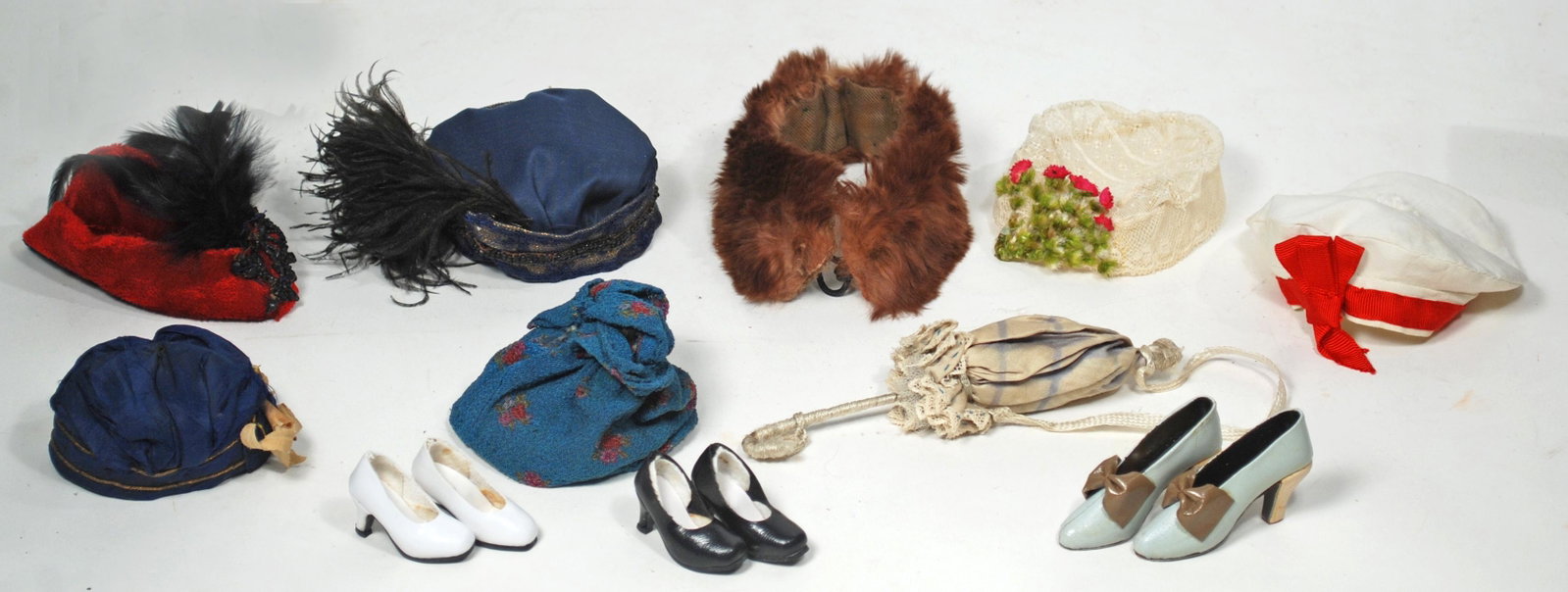 DOLL BONNETS, SHOES, FUR STOLE, PARASOL Six bonnets: DOLL BONNETS, SHOES, FUR STOLE, PARASOL Six bonnets (silk, velvet and lace) for 6" to 9" head circumference; three pair of high heel doll shoes, 10" L fur stole, 6" L silk parasol Commentary: Antique 