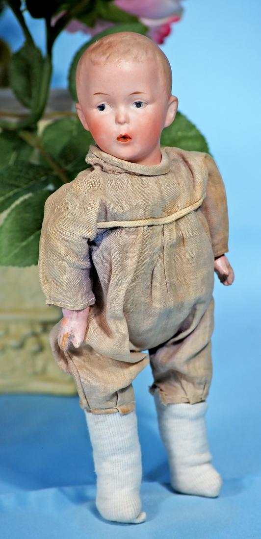 GERMAN BISQUE DOLL KNOWN AS "WHISTLING JIM" BY GEBRUDER: GERMAN BISQUE DOLL KNOWN AS "WHISTLING JIM" BY GEBRUDER HEUBACH. Marks: Heubach in square. 9". Bisque swivel head, flange neck, molded and painted blonde hair, painted features, intaglio blue eyes, ta
