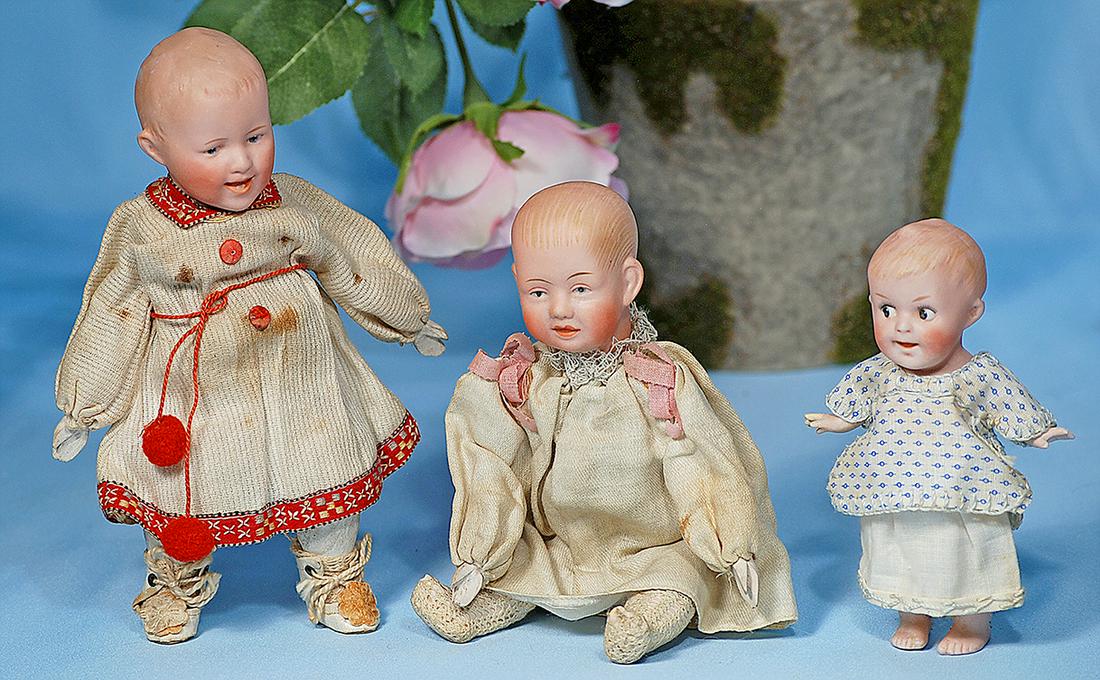 GERMAN BISQUE DOLL WITH CLAPPING HANDS BY GEBRUDER: GERMAN BISQUE DOLL WITH CLAPPING HANDS BY GEBRUDER KNOCH. Marks: Made in Germany 200-23. 8". Bisque shoulderhead with brushmarked blonde hair, painted features, intaglio blue eyes, arched brows, open/