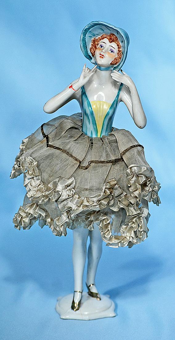 VERY FINE GERMAN PORCELAIN HALF DOLL AS CANDY: VERY FINE GERMAN PORCELAIN HALF DOLL AS CANDY CONTAINER. Marks: Dep Germany 5227. 11". Porcelain half doll with uptilted head, sculpted aqua bonnet and auburn hair, painted brown eyes with amber eyesh