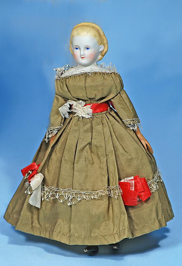 GERMAN BISQUE LADY WITH "ALICE" HAIR STYLE. Marks:: GERMAN BISQUE LADY WITH "ALICE" HAIR STYLE. Marks: None. 9". Bisque shoulderhead with sculpted blonde hair pulled away from face and secured by headband, fully-modelled ears, painted features, blue ey