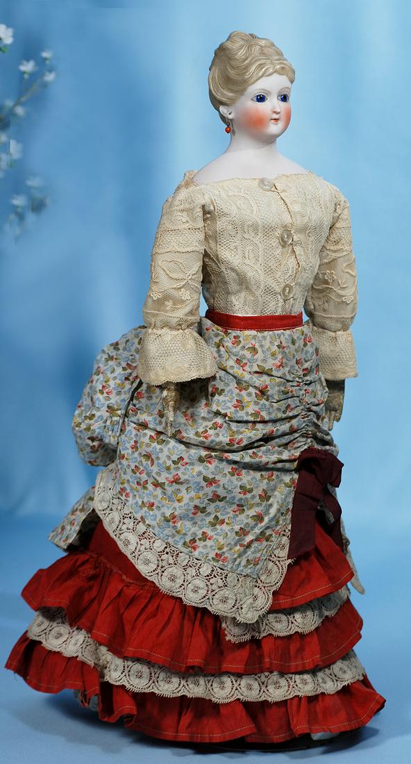 GERMAN BISQUE PARIAN LADY WITH COBALT GLASS EYES AND: GERMAN BISQUE PARIAN LADY WITH COBALT GLASS EYES AND RARE HAIR STYLE. Marks: None. 20". Bisque shoulderhead with café au-lait sculpted hair which is parted at center and drawn up and away into entwin