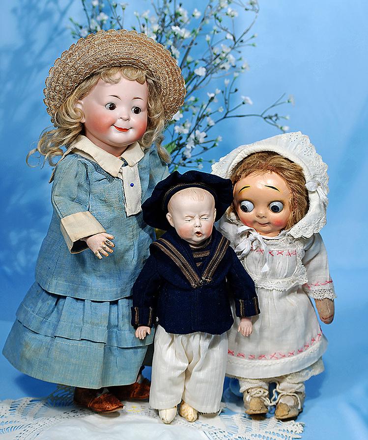 LARGE SIZE "HUG ME KIDDIES" GOOGLY. 12". Composition: LARGE SIZE "HUG ME KIDDIES" GOOGLY. 12". Composition mask-face with large blue glass side-glancing eyes, high arched brows, closed mouth, tiny nose, original brown mohair wig, pink felt cloth body wit