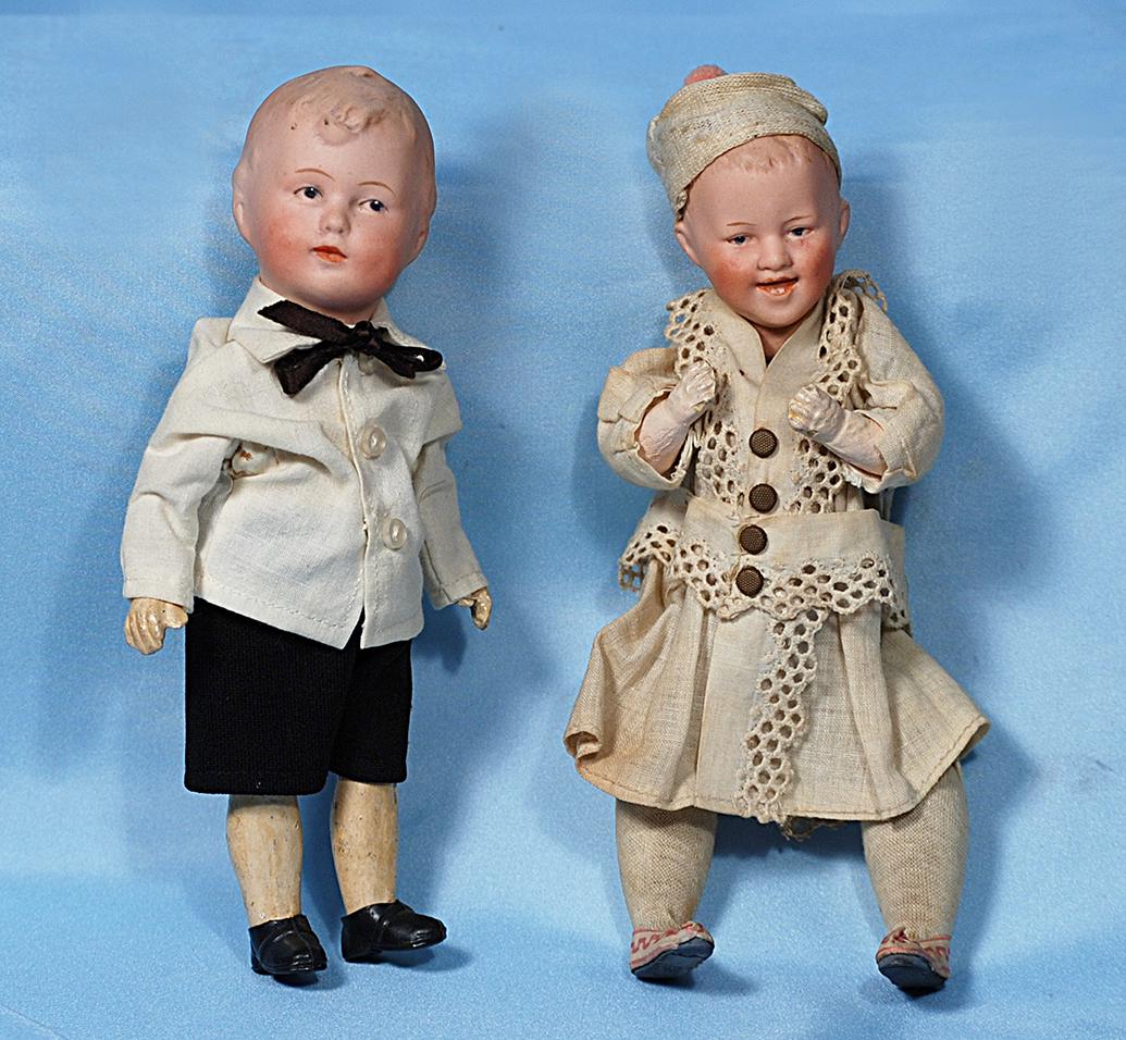 GERMAN BISQUE WALKING CHARACTER BY GEBRUDER HEUBACH.: GERMAN BISQUE WALKING CHARACTER BY GEBRUDER HEUBACH. Marks: Heubach symbol, Germany. 7 ½". Bisque solid-dome head with molded and painted blonde hair, blue intaglio eyes, tapered brows, open/closed m
