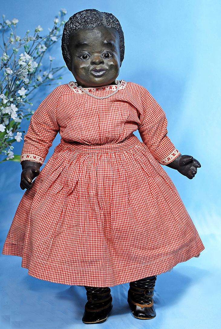 BLACK PAPER MACHE PORTRAIT CHILD "HATTIE JO" BY LEO: BLACK PAPER MACHE PORTRAIT CHILD "HATTIE JO" BY LEO MOSS. Marks: Hattie Jo 1923 (label sewn on chest). 22". Black paper mache swivel head with flange neck, rich dark brown complexion, sculpted and ver