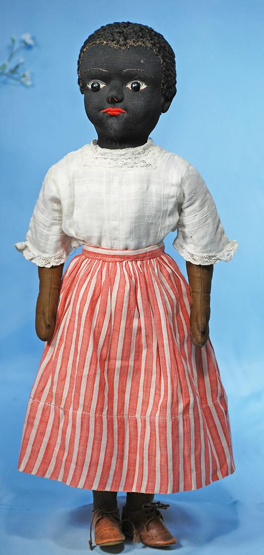 AMERICAN BLACK STOCKINETTE DOLL BY JULIA BEECHER. 20".: AMERICAN BLACK STOCKINETTE DOLL BY JULIA BEECHER. 20". Firmly-stuffed black stockinette head, stitched facial features, cut-out eye sockets with large black shoe button eyes on white background with p