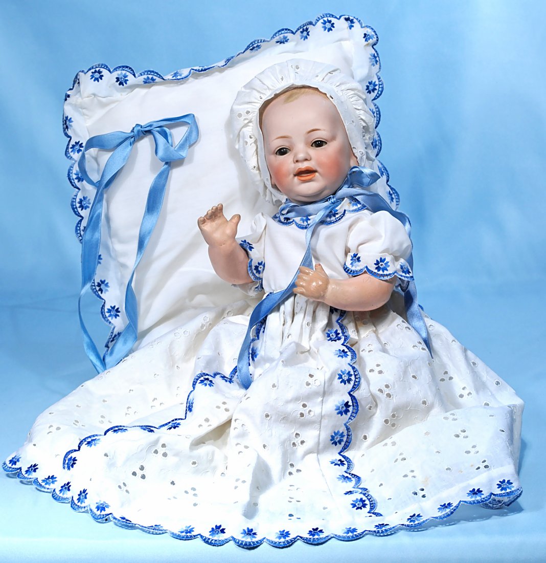 KESTNER, JDK, BISQUE CHARACTER BABY: 308. GERMAN BISQUE J.D.K. CHARACTER BABY BY KESTNER WITH MATCHING GOWN AND BLANKET. Marks: JDK 19. 16”. Solid dome bisque socket head with painted blonde hair, brown sleep eyes, painted lashes, feat