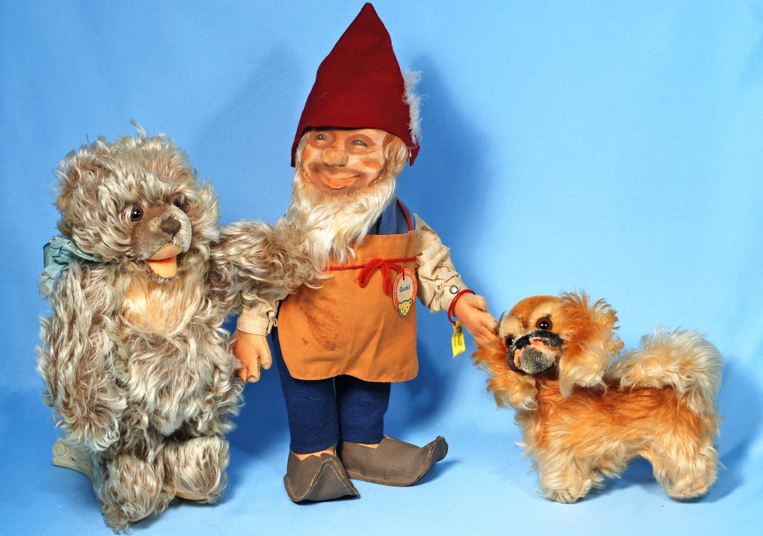 STEIFF “GUCKI” DOLL, STEIFF BEAR AND PUP: 291-A. STEIFF “GUCKI” DOLL, STEIFF BEAR AND PUP. 13” Steiff gnome “Gucki” rubber head doll with jointed felt body, original costume, Steiff button and name tag. 10” Steiff silky mohair bea
