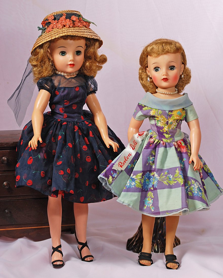TWO ALL-ORIGINAL “MISS REVLON” FASHION DOLLS BY IDEAL: 54.TWO ALL-ORIGINAL “MISS REVLON” FASHION DOLLS BY IDEAL.Each is vinyl socket head, lady body, swivel waist, sleep eyes, rooted saran hair. (1) 20” Miss Revlon in “Cherries A LaMode” in 1957
