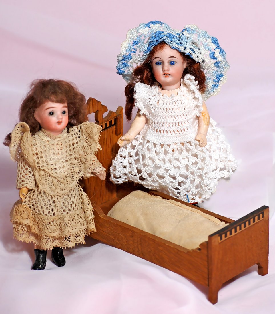 TWO MINIATURE GERMAN BISQUE DOLLS AND DOLLHOUSE BED (1 of 1)