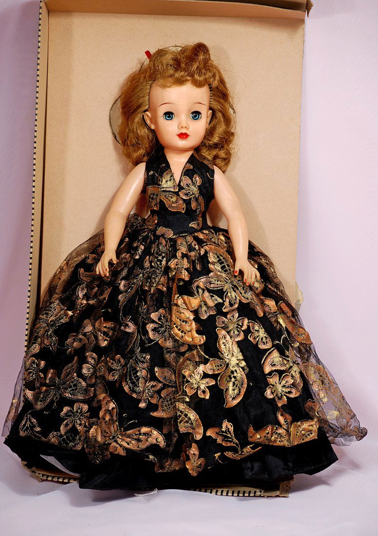 IDEAL MISS REVLON IN SHIMMERNG FORMAL GOWN.: 94. IDEAL MISS REVLON IN SHIMMERING FORMAL GOWN. 18”. Vinyl socket head, five-piece jointed body, rooted brown hair, wears black tulle formal with lavish gilt designs, black taffeta under dress, fit