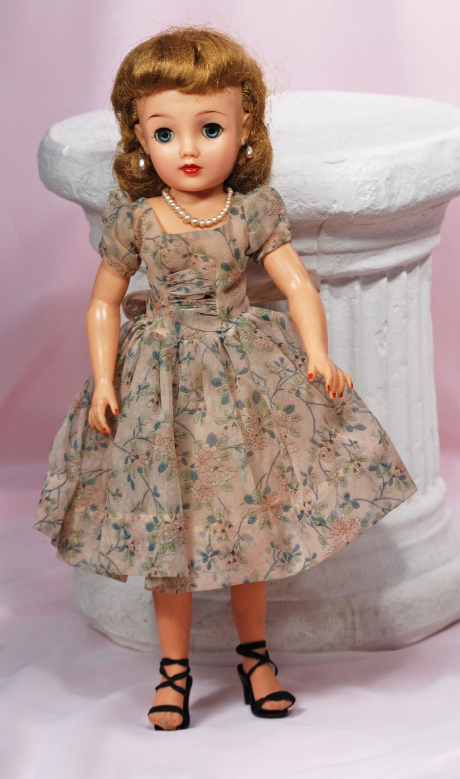 IDEAL MISS REVLON IN FLOWERED GARDEN PARTY DRESS: IDEAL MISS REVLON IN FLOWERED GARDEN PARTY DRESS. 18". Vinyl socket head, lady body with swivel waist, jointing at shoulders and hips, blue sleep eyes, painted lower lashes and feathered brows, cherry