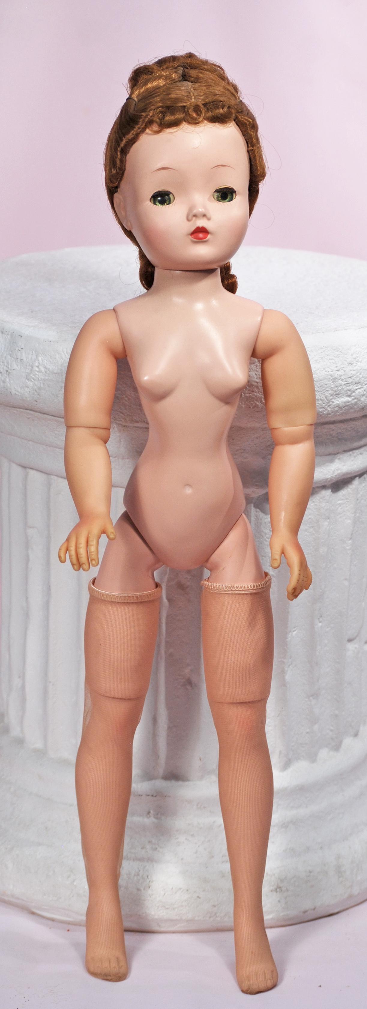 ALEXANDER BROWN-HAIRED NUDE CISSY: ALEXANDER BROWN-HAIRED NUDE CISSY. 20". All-hard plastic with jointed vinyl arms, styled hair, sleep eyes, painted and applied lashes, red lips, hose, undressed doll. Commentary: Very good condition.