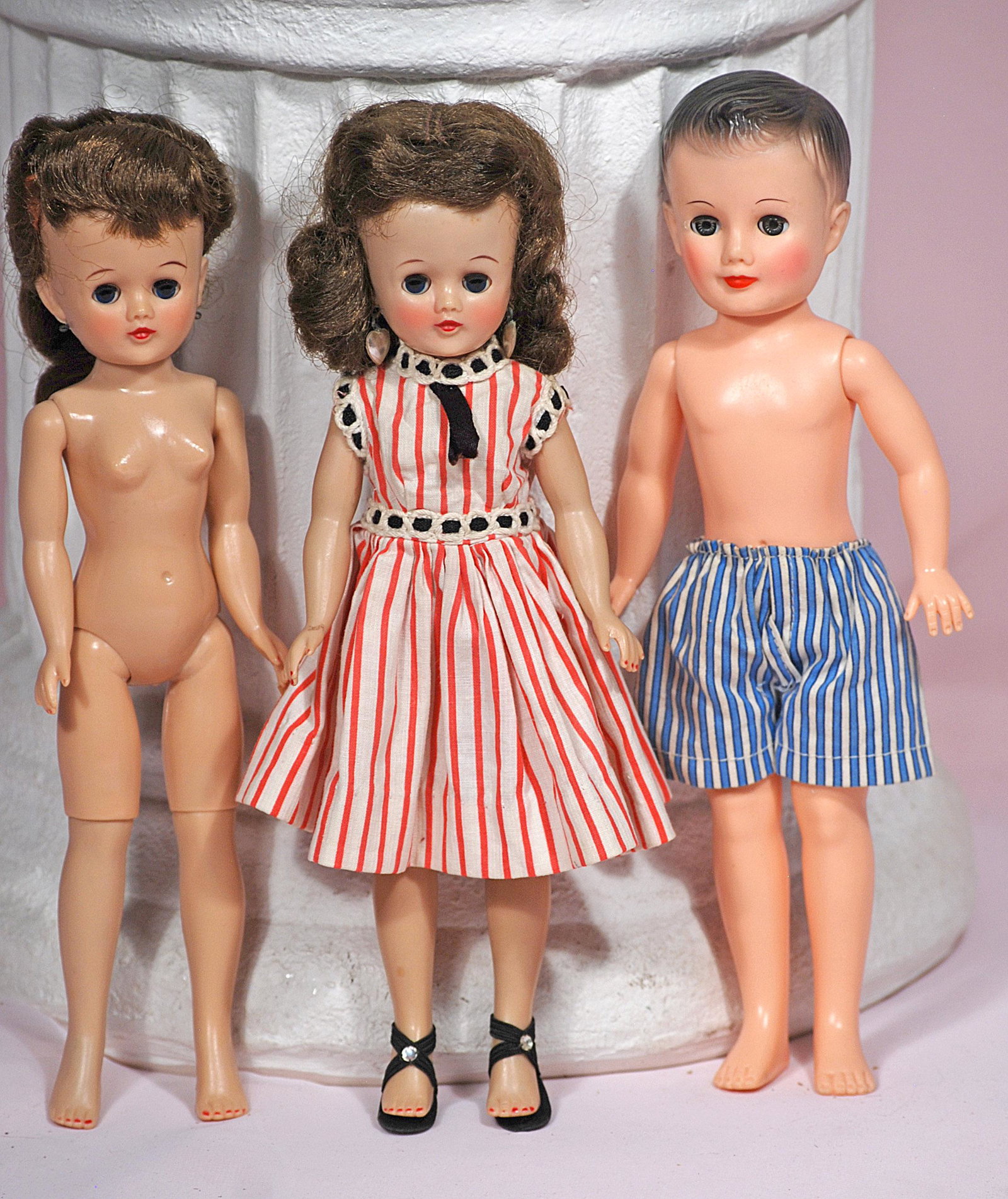 VOGUE JEFF AND TWO JILL DOLLS: VOGUE JEFF AND TWO JILL DOLLS. 10". Jill is hard plastic with sleep eyes, brunette wig, jointed lady body; one nude and one in original coral and white striped cotton dress, black high heels; Jeff is 