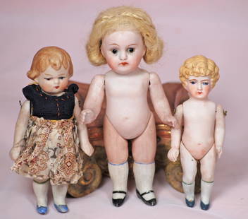 THREE GERMAN ALL-BISQUE DOLLS: THREE GERMAN ALL-BISQUE DOLLS. 5 1/4" Kestner marked 150, jointed shoulders and hips, glass eyes, mohair wig; 4 1/4" doll with molded hair and painted features; 4 1/4" doll with molded hair and painte