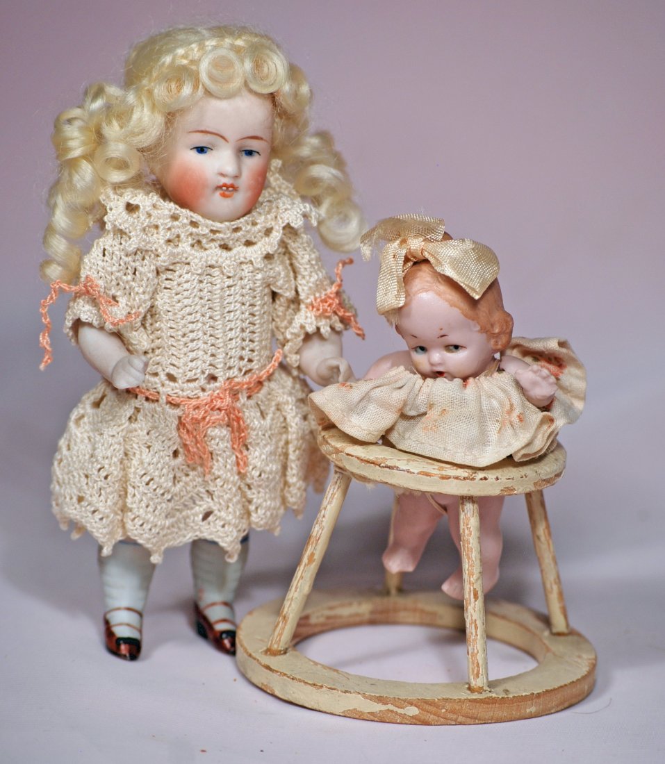 KESTNER ALL-BISQUE DOLL & BISQUE BABY IN "TENDA": 91. KESTNER ALL-BISQUE DOLL & BISQUE BABY IN "TENDA". 5 1/2" Kestner marked 150, painted features, open/closed mouth with tiny bead teeth, blonde mohair wig, jointed shoulders and hips, painted shoes 