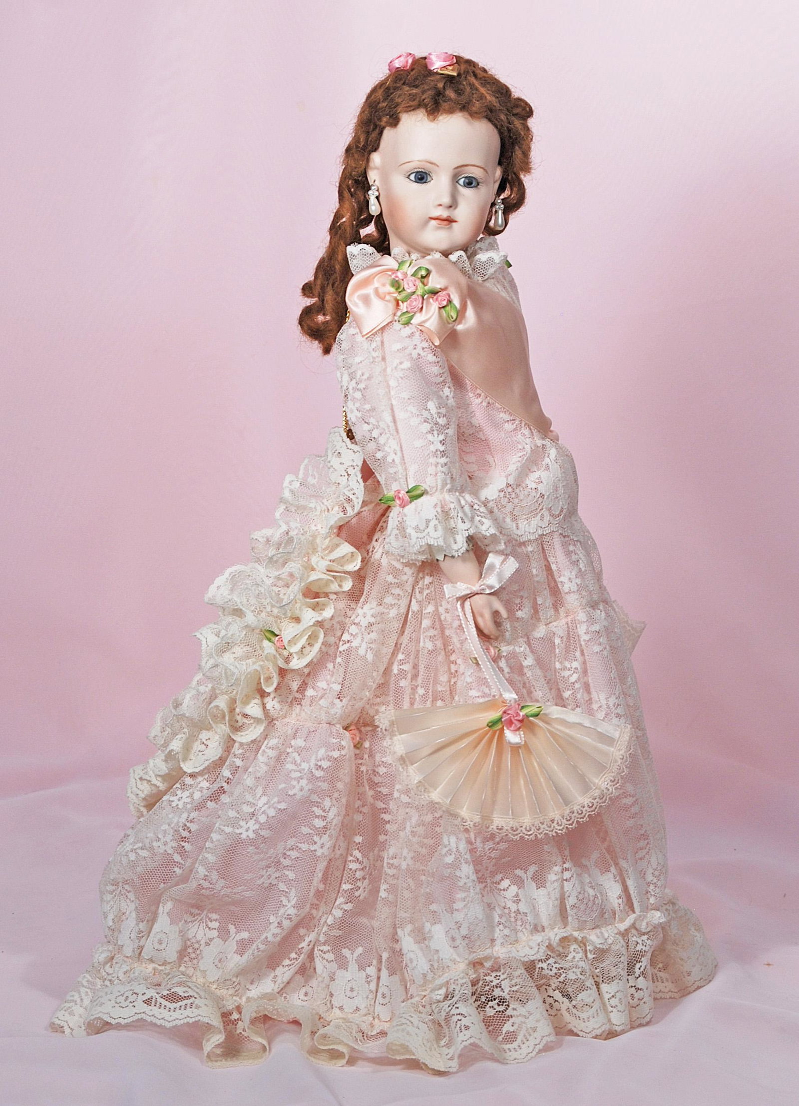 BISQUE REPRODUCTION OF JUMEAU FASHION DOLL: BISQUE REPRODUCTION OF JUMEAU FASHION DOLL. 18". Bisque swivel head on bisque shoulderplate, blue glass eyes, closed mouth, mohair wig, kid fashion body with bisque lower arms, pink silk and lace cost