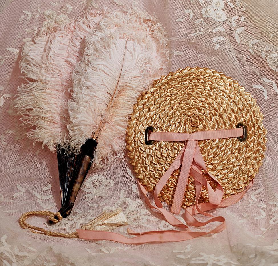 OSTRICH FEATHER AND TORTOISE SHELL FAN PLUS STRAW DOLL: OSTRICH FEATHER AND TORTOISE SHELL FAN PLUS STRAW DOLL BONNET. 12” pink ostrich feather fan has eighteen tortoise shell sticks plus loop and cord with tassels; Natural straw bonnet has pink ribbon s
