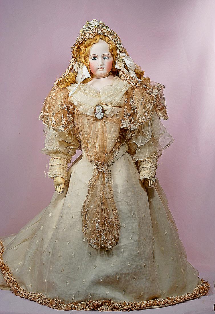 MAGNIFICENT FRENCH BISQUE PORTRAIT POUPEE BY: MAGNIFICENT FRENCH BISQUE PORTRAIT POUPEE BY PIERRE-FRANCOIS JUMEAU WITH TRUNK AND TROUSSEAU. 33”. Pressed bisque swivel head on bisque shoulderplate, inset blue glass enamel eyes, dark eyeliner, pa
