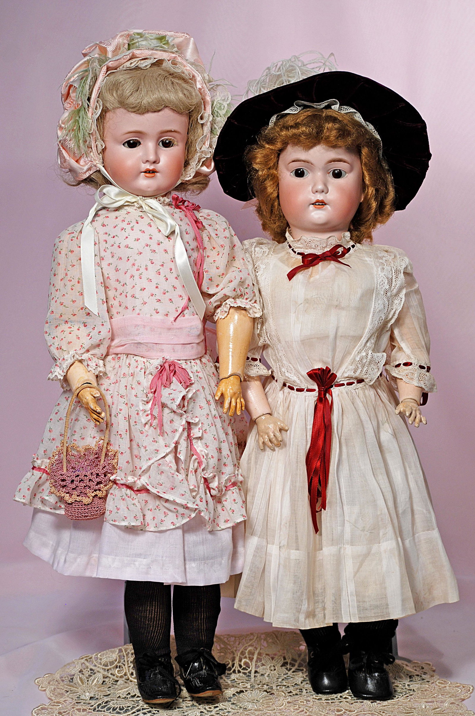 TWO GERMAN BISQUE DOLLS: TWO GERMAN BISQUE DOLLS. (1) Bisque child by mystery maker. Marks: P. W. II Germany. 23" bisque socket head, painted lashes, feathered brows, open mouth, upper teeth, synthetic wig, composition ball-j