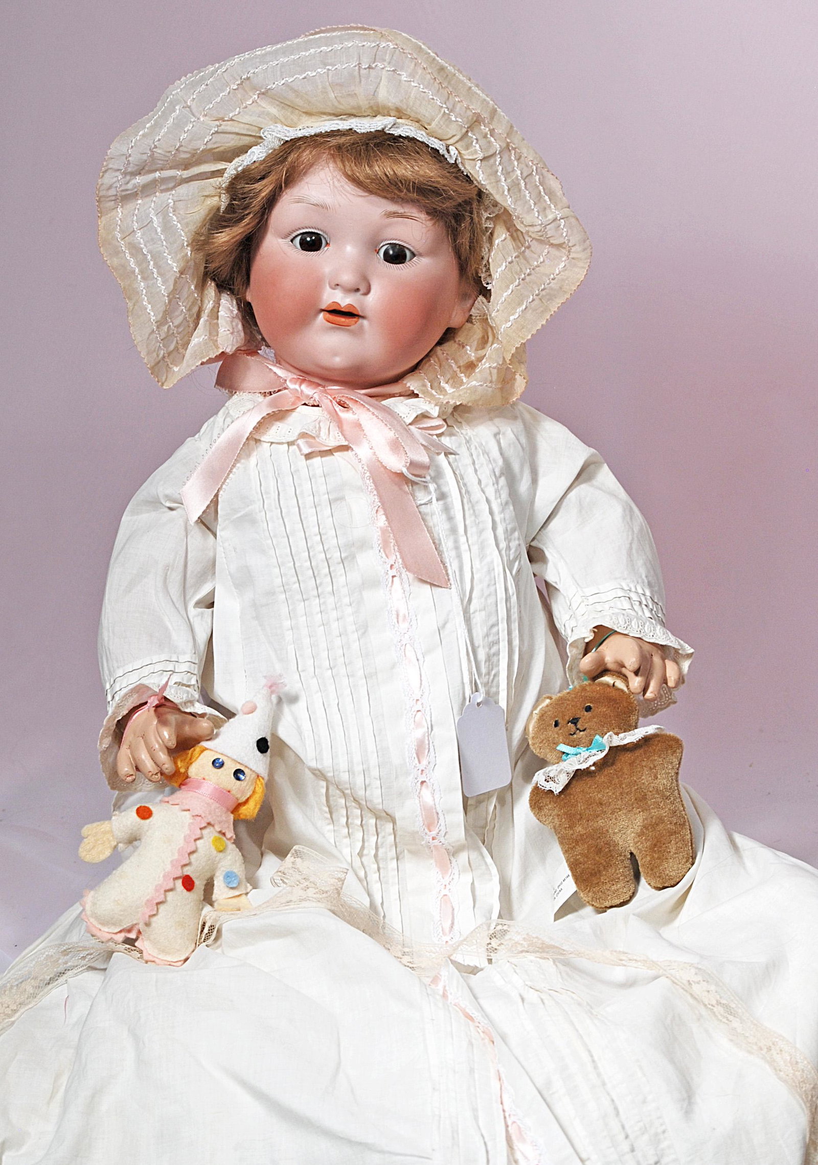 GERMAN BISQUE CHARACTER WITH TODDLER BODY BY MARSEILLE: GERMAN BISQUE CHARACTER WITH TODDLER BODY BY MARSEILLE. 23”. Marks: A.M. 985. Bisque socket head, brown sleep eyes, painted lashes, open mouth, upper teeth, synthetic wig, five-piece composition joi