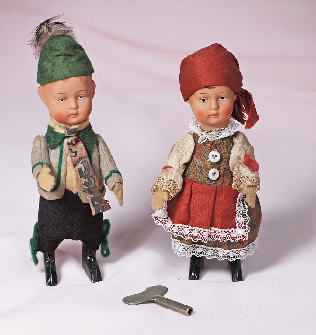 VINTAGE TINY WIND-UP KATHE KRUSE-TYPE DOLLS: 243. VINTAGE TINY WIND-UP KATHE KRUSE-TYPE BOY AND GIRL.4”. Painted bisque head, painted features and hair, felt hands, tin body with key hole at back, original provincial costumes. Commentary: All-