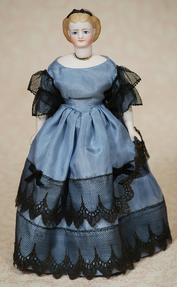 PETITE BISQUE PARIAN-TYPE LADY WITH SWIVEL NECK: PETITE BISQUE PARIAN-TYPE LADY WITH SWIVEL NECK. 8 ½”. Bisque swivel head on kid-lined bisque shoulderplate, sculpted café au lait waved behind modeled ears and accented with black rib