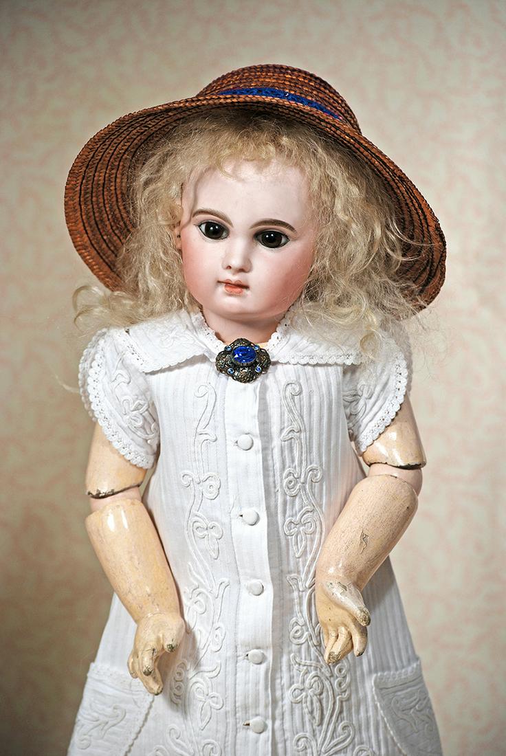 BEAUTIFUL E: BEAUTIFUL E. J. 10 BEBE BY EMILE JUMEAU. 22”. Marks: Depose E. 10 J. Bisque socket head, large brown paperweight eyes, painted lashes, eyeliner mauve-blushed eye shadow, feathered and brushstrok