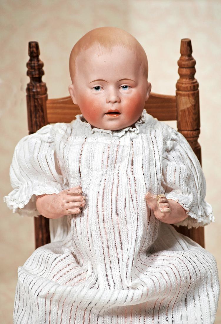 GERMAN BISQUE "D 1" CHARACTER BABY BY: GERMAN BISQUE "D 1" CHARACTER BABY BY SWAINE. 11". Marks: D. 1 (incised) plus green stamp of Swaine & Co. Solid-dome bisque socket head, painted hair, painted features, blue intaglio eyes, tapered bro