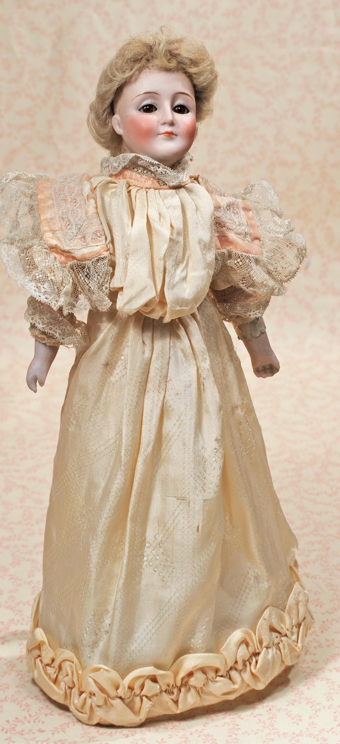 GERMAN BISQUE GIBSON GIRL BY KESTNER: GERMAN BISQUE GIBSON GIRL BY KESTNER. 13”. Marks: 172. Bisque shoulderhead, blue sleep eyes, painted lashes, tapered brows, closed mouth, original blonde mohair wig over plaster pate, kid body w