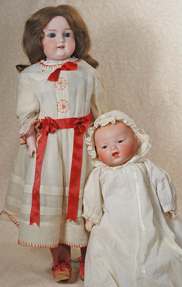 TWO GERMAN BISQUE DOLLS BY MARSEILLE.: 268.TWO GERMAN BISQUE DOLLS BY MARSEILLE.(1) 24" marked A.M. 370, shoulderhead, sleep eyes, painted lashes, open mouth, upper teeth, brown human hair wig, pin-jointed kid body with composition lower l