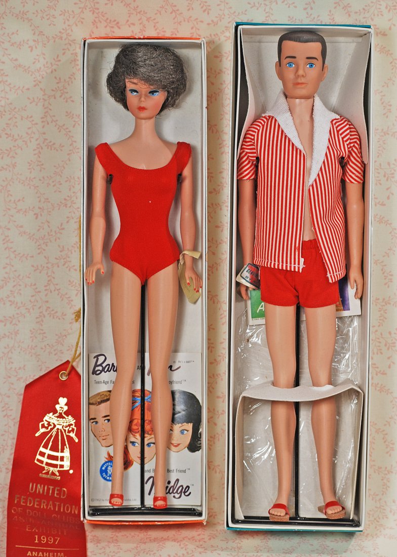 1962 BUBBLE CUT BARBIE AND FLOCKED HAIR KEN.: 289. 1962 BUBBLE CUT BARBIE AND FLOCKED HAIR KEN. Barbie in red jersey swimsuit, red high heels, metal stand, wrist tag, booklet and original box; Ken in red and white swim attire, red sandals, metal 