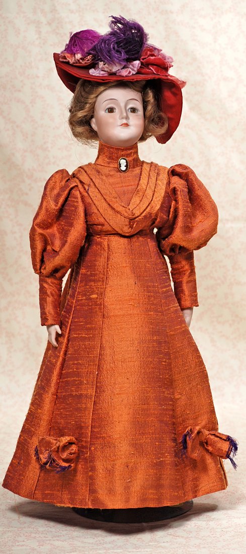 BISQUE GIBSON GIRL REPRODUCTION: 300. BISQUE GIBSON GIRL REPRODUCTION. Marks: Landon. 16”. Bisque shoulderhead, brown glass eyes, closed mouth, human hair wig, cloth lady body with bisque lower limbs and sculpted bisque boots, dark