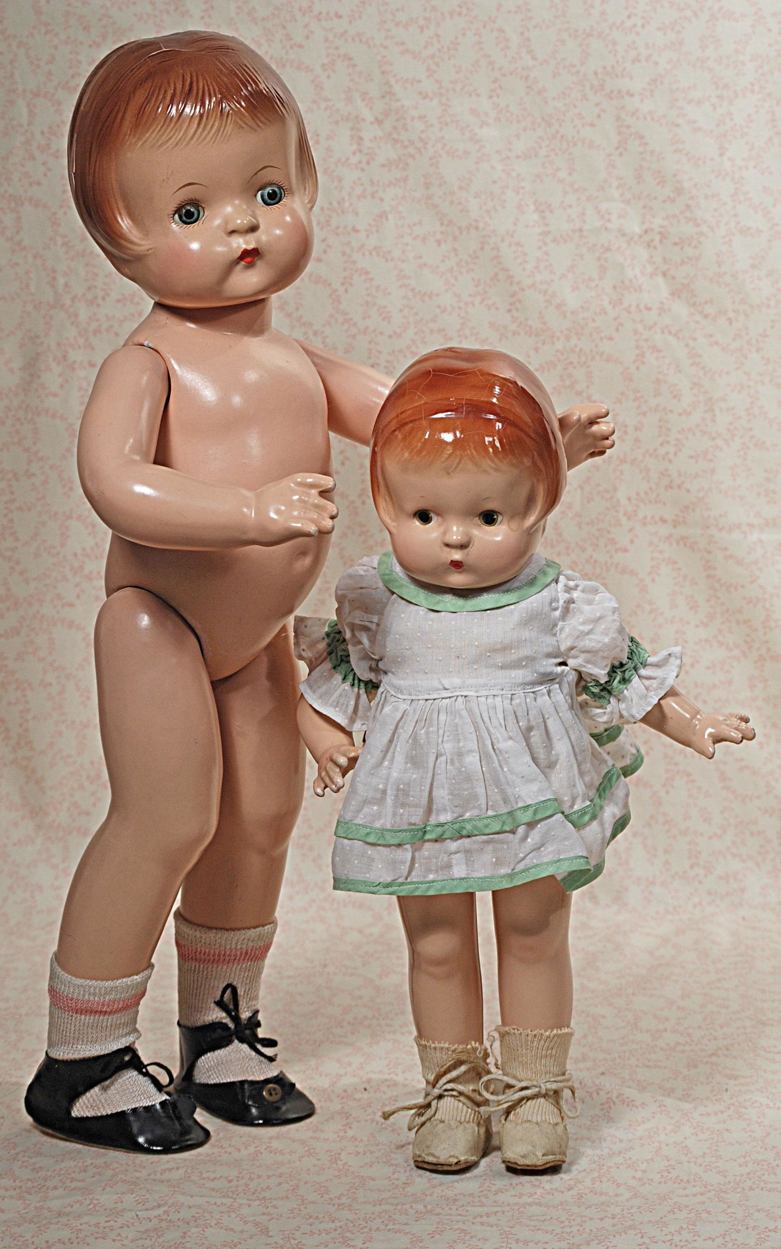 TWO COMPOSITION PATSY DOLLS BY EFFANBEE: TWO COMPOSITION PATSY DOLLS BY EFFANBEE. 19" Patsy Ann with sleep eyes, molded hair, nude; 14" Patsy with painted eyes and molded hair, cotton dress, old shoes and socks. Commentary: Some lifting of c