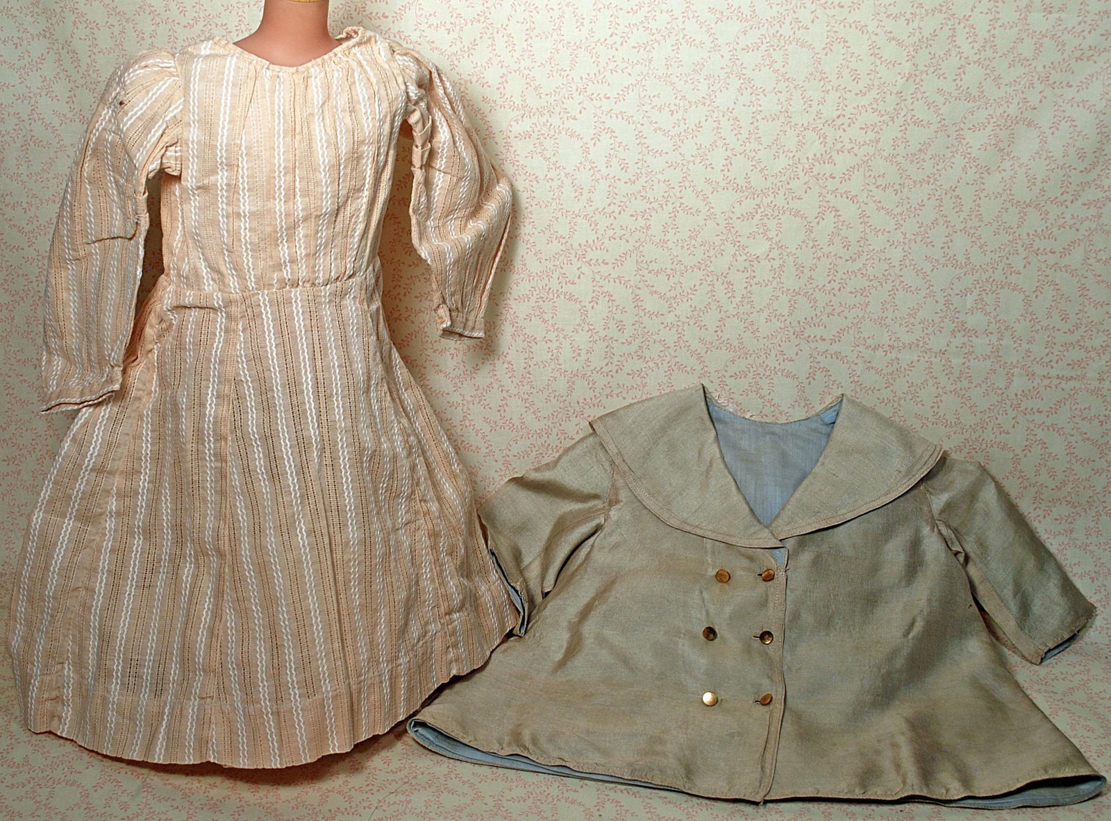 ASSORTED DOLL CLOTHING & DOLL BOOK.: ASSORTED DOLL CLOTHING & DOLL BOOK. "The Beautiful Jumeau" doll book. Clothing includes five pieces underclothing, baby dress and bonnet, 12"-13" cotton dress and cotton coat, antique silk coat with p