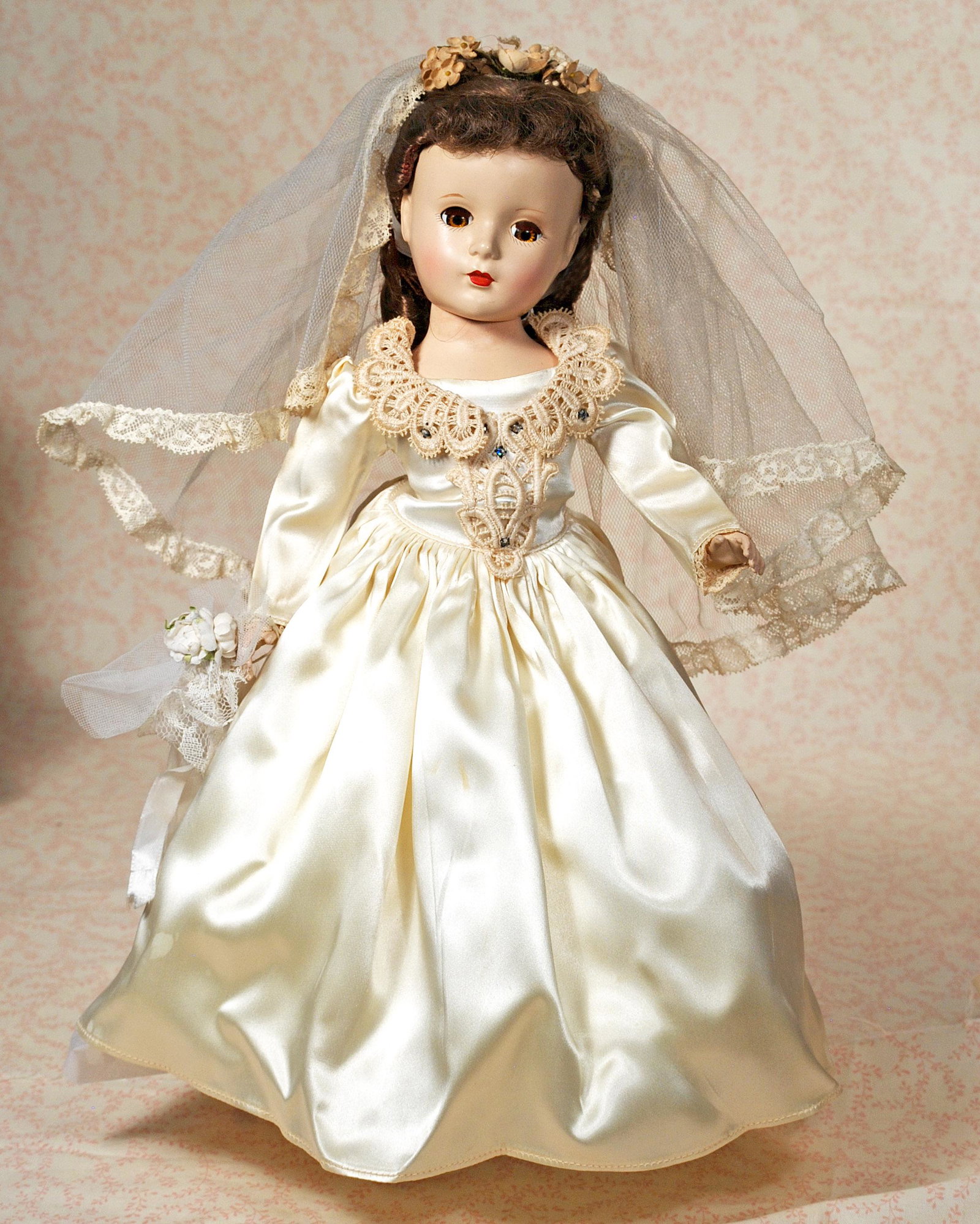 ALEXANDER HARD PLASTIC “LUCY BRIDE” IN ORIGINAL GOWN.: ALEXANDER HARD PLASTIC “LUCY BRIDE” IN ORIGINAL GOWN. 14". Hard plastic socket head on five-piece jointed body, brown sleep eyes, painted and applied lashes, ruby lips, original brown hair in orig