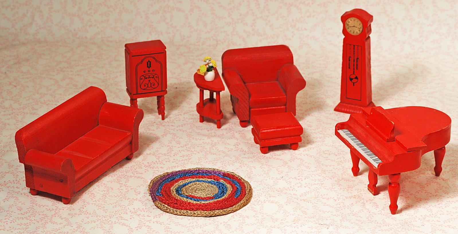 DOLL FURNITURE BY STROMBECKER.: DOLL FURNITURE BY STROMBECKER. Seven pieces of painted red wooden dollhouse furniture including sofa, chair, foot stool, side table, grandfather clock, radio and grand piano; plus seven pieces of pain
