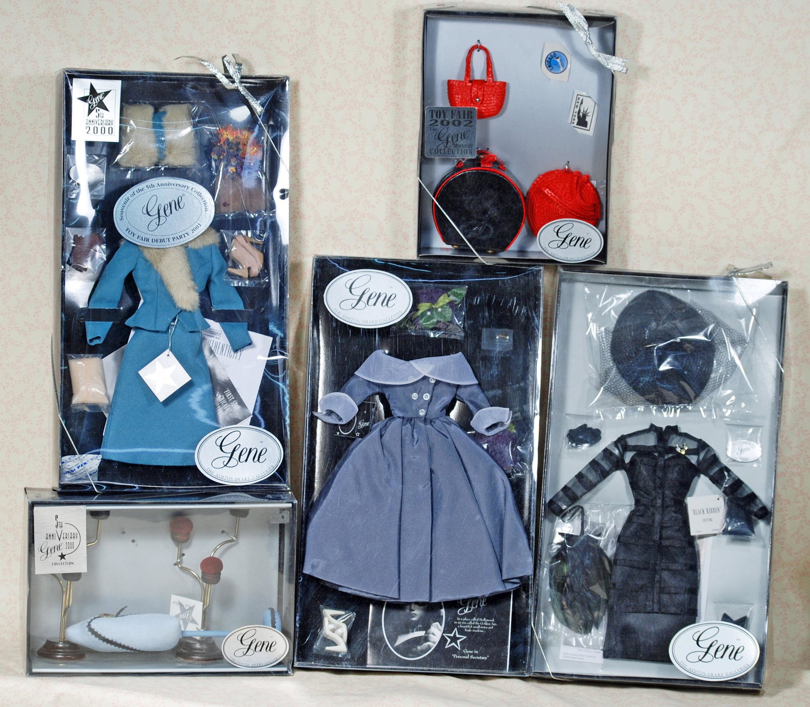 BOXED FASHIONS AND ACCESSORIES FOR GENE DOLL.: BOXED FASHIONS AND ACCESSORIES FOR GENE DOLL. Includes: Black Ribbon costume; 5th Anniversary "First Stop Chicago" costume; Personal Secretary costume; 2002 Toy Fair Gene Marshall collection; 5th Anni