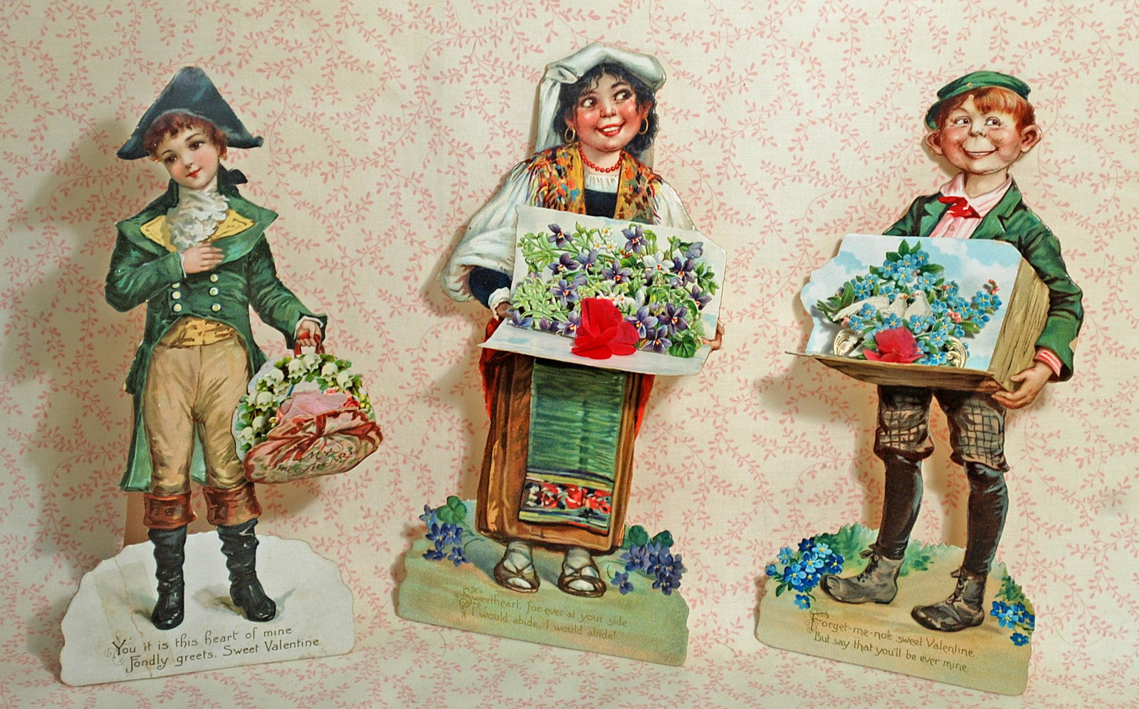 RAPHAEL TUCK VALENTINES, ADVERTISING FAN & CHILDRENS’S: RAPHAEL TUCK VALENTINES, ADVERTISING FAN & CHILDRENS’S BOOKS. Three 9" figural valentines with Raphael Tuck stamp on back, two missing the cardboard stand backing; otherwise very good condition. 11"