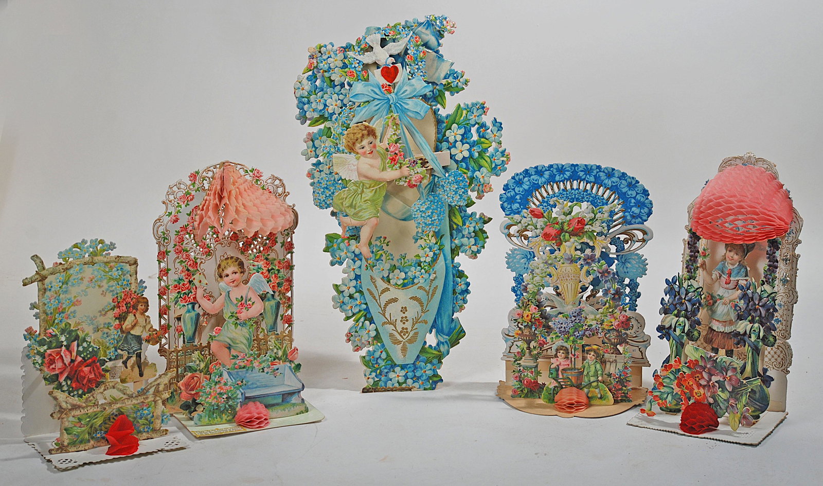 FIVE ANTIQUE DIMENSIONAL FOLD-OUT VALENTINES.: FIVE ANTIQUE DIMENSIONAL FOLD-OUT VALENTINES. Largest is 12". Embossed lithographed die-cut and honeycomb group of Valentine greetings, one marked Raphael Tuck. Good to Excellent, 1900s.