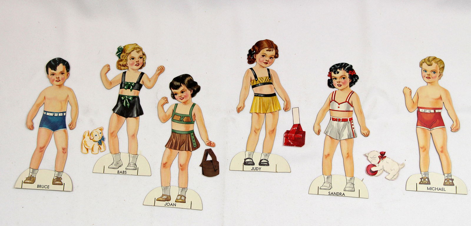 AMERICAN BOXED "PAPER DOLL BAZAR" BY GABRIEL: AMERICAN BOXED "PAPER DOLL BAZAR" BY GABRIEL. Original box with six 8" paper dolls: Babs, Judy, Joan, Sandra, Michael, and Bruce, each with several outfits, toys, and more. Saml Gabriel Sons & Co., Ne