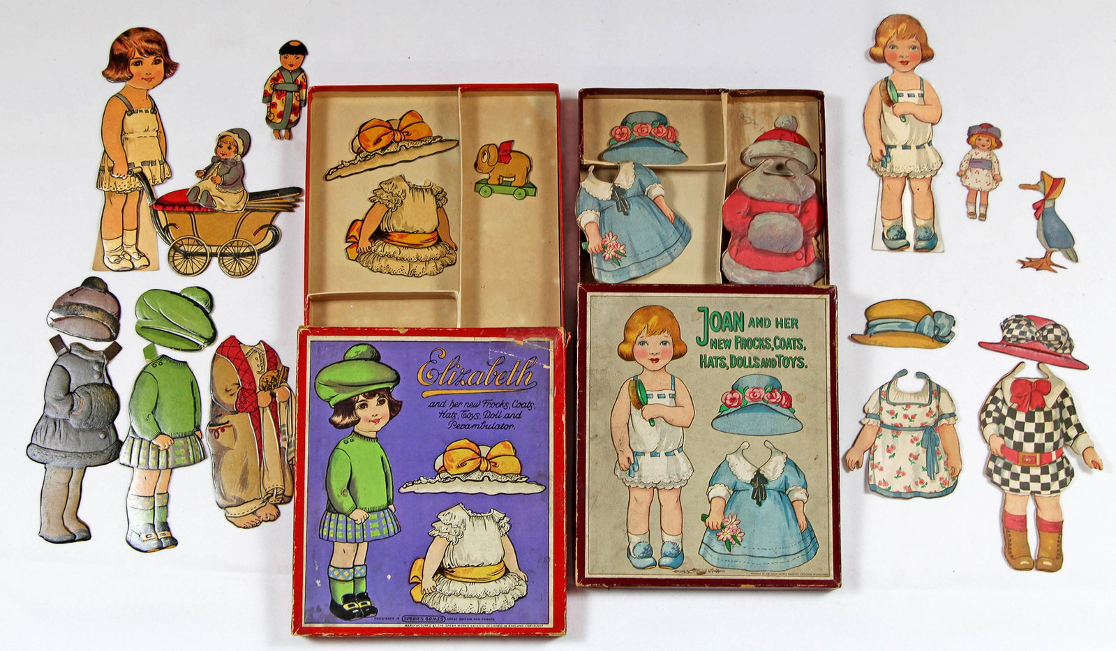 TWO ENGLISH BOXED PAPER DOLLS BY SPEAR: TWO ENGLISH BOXED PAPER DOLLS BY SPEAR. Two 7 1/2" dolls Elizabeth and Joan with their new frocks, coats, hats, dolls, and toys, made of heavy cardboard with embossed varnished detail. Designed in Eng