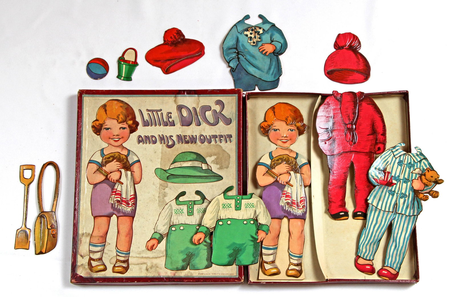 ENGLISH "LITTLE DICK AND HIS NEW OUTFIT" BOXED: ENGLISH "LITTLE DICK AND HIS NEW OUTFIT" BOXED PAPERDOLL BY SPEAR. Contained in original box with colorful cover is one 10 1/4" doll with 4 outfits, 2 hats, shoulder bag, and toys made of heavy cardbo