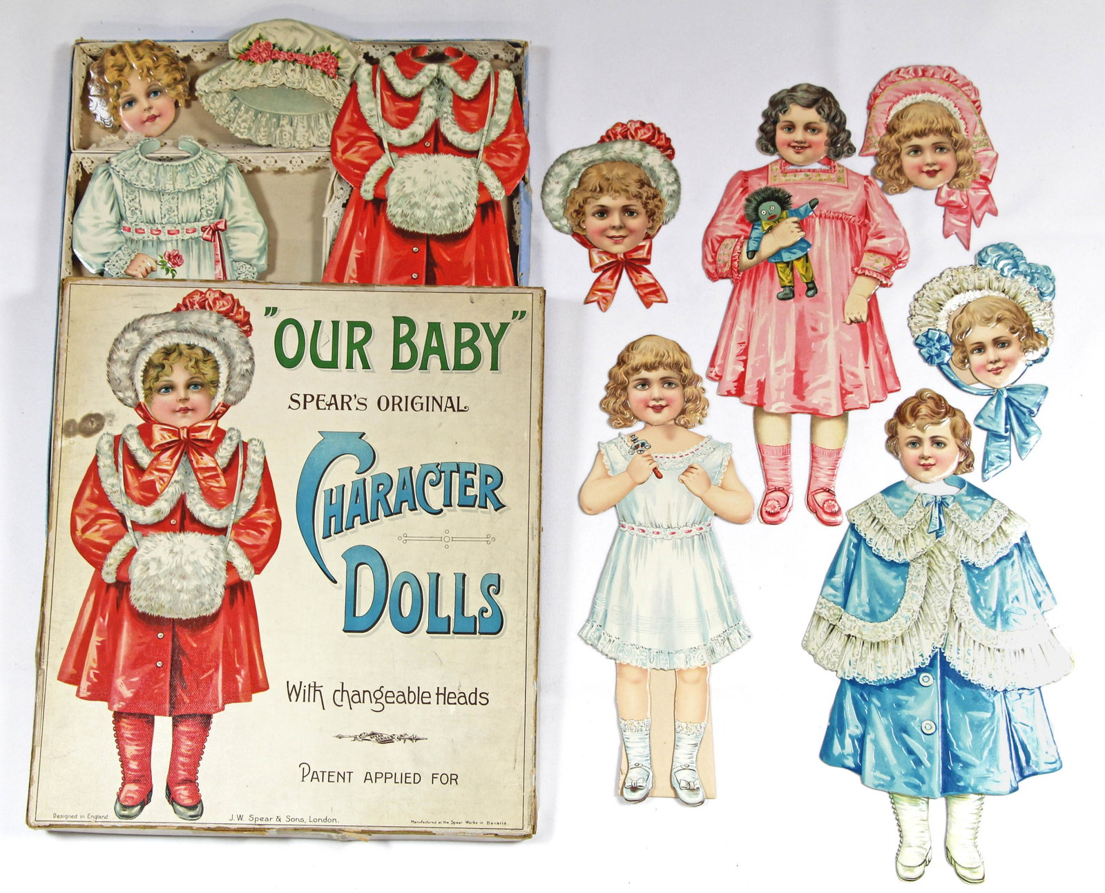 ENGLISH CHARACTER PAPER DOLL "OUR BABY" BY SPEAR: ENGLISH CHARACTER PAPER DOLL "OUR BABY" BY SPEAR. 12" doll, 14" x 12" box. Contained in original box with colorful cover and laced interior sections is one paper doll with 7 changeable heads, 4 frocks