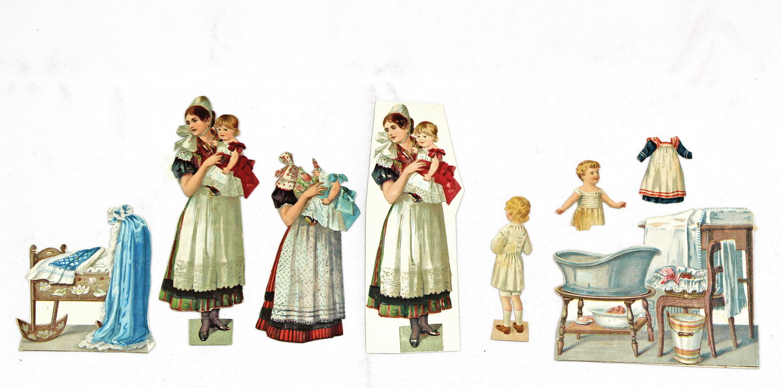 WOMAN WITH BABY AND CHILD, GERMANY: WOMAN WITH BABY AND CHILD, GERMANY. 6 1/2" engraved and embossed paper doll young woman holding a baby (two sets) and one 3" child with extra costume plus several pieces of furniture including a crib,