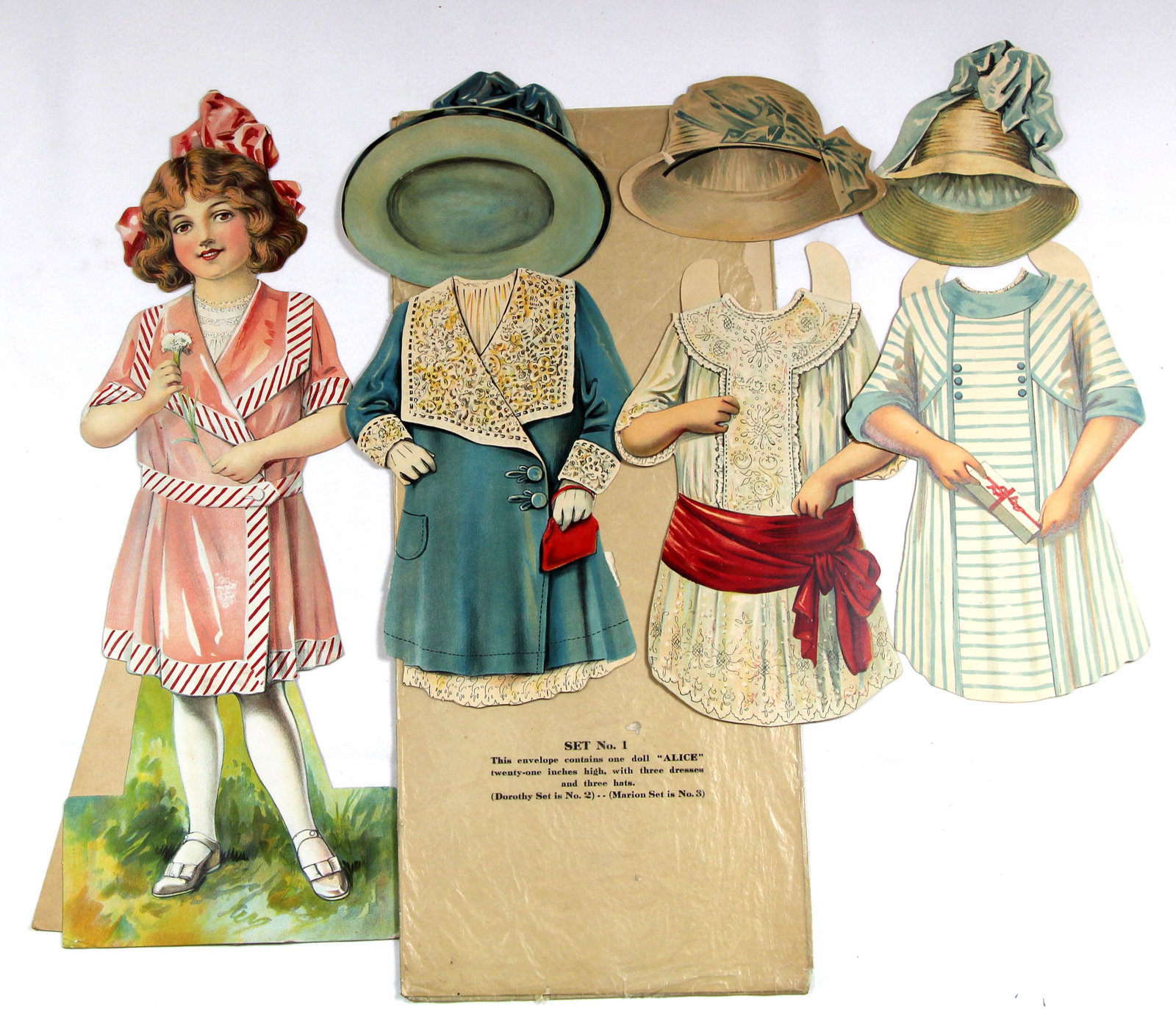 AMERICAN PAPER DOLLS SET "ALICE", "DOROTHY", "MARION": AMERICAN PAPER DOLLS SET "ALICE", "DOROTHY", "MARION" FROM WOOLWORTH SERIES. 21". Each is single-sided cardboard doll, with 3 costumes and 3 hats. Alice has original envelope, Dorothy and Marion are a