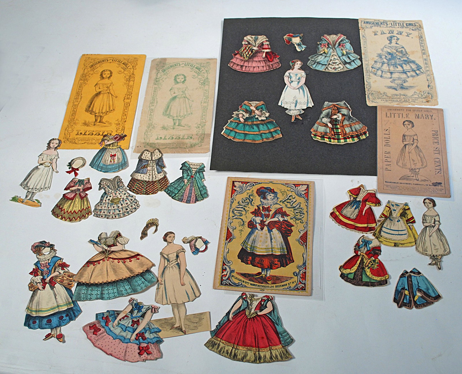 FOUR EARLY PAPER DOLLS BY MCLOUGHLIN: FOUR EARLY PAPER DOLLS BY MCLOUGHLIN. Includes: 4” Lizzie with five dresses and one bonnet, two booklets and envelopes; 4 1/2" Fancy Nancy with four dresses and two bonnets, original booklet and env