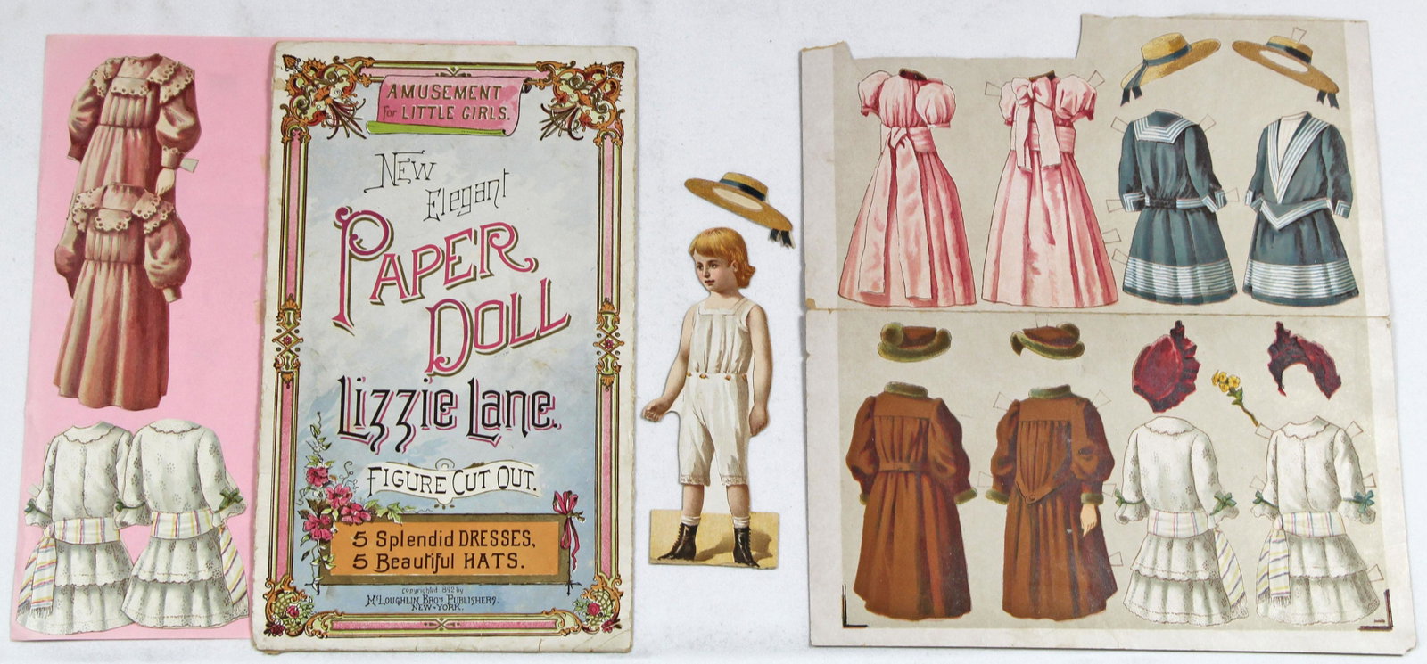 THREE ELEGANT PAPER DOLLS SERIES BY MCLOUGHLIN, 1892.: THREE ELEGANT PAPER DOLLS SERIES BY MCLOUGHLIN, 1892. 6 1/2" to 7" double sided paper dolls and costumes; 8" x 11" envelope. Includes: Lizzie Lane with 4 uncut and 2 cut costumes and envelope; Karl Ki
