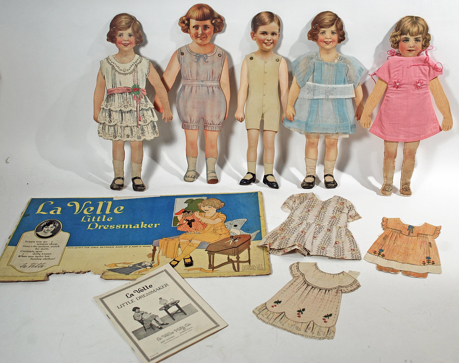 FIVE AMERICAN ARTICULATED PAPER DOLLS: FIVE AMERICAN ARTICULATED PAPER DOLLS. 13 1/2" heavy cardboard cut-out paper dolls with articulated arms; two have handmade dresses plus additional cotton print dress and two paper dresses, Lavelle Li