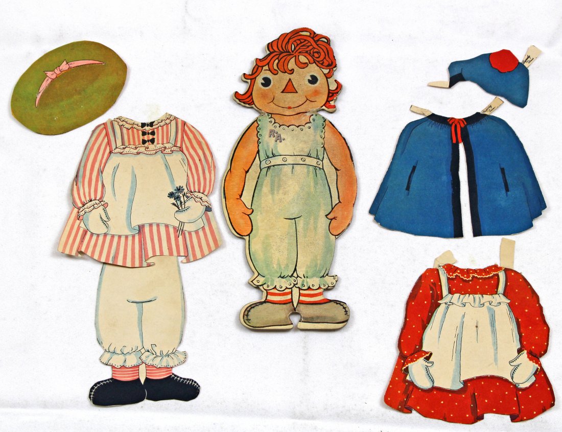 RAGGEDY ANN AND 4 WIGGLEY EYES CUT OUTS: RAGGEDY ANN AND 4 WIGGLEY EYES CUT OUTS. 10" heavy cardstock Raggedy Ann with 3 tagged paper costumes; And, four 7 1/2" x 9" pages two girls and 2 boys, Wiggley Eyes Cut Out. Commentary: Raggedy Ann h